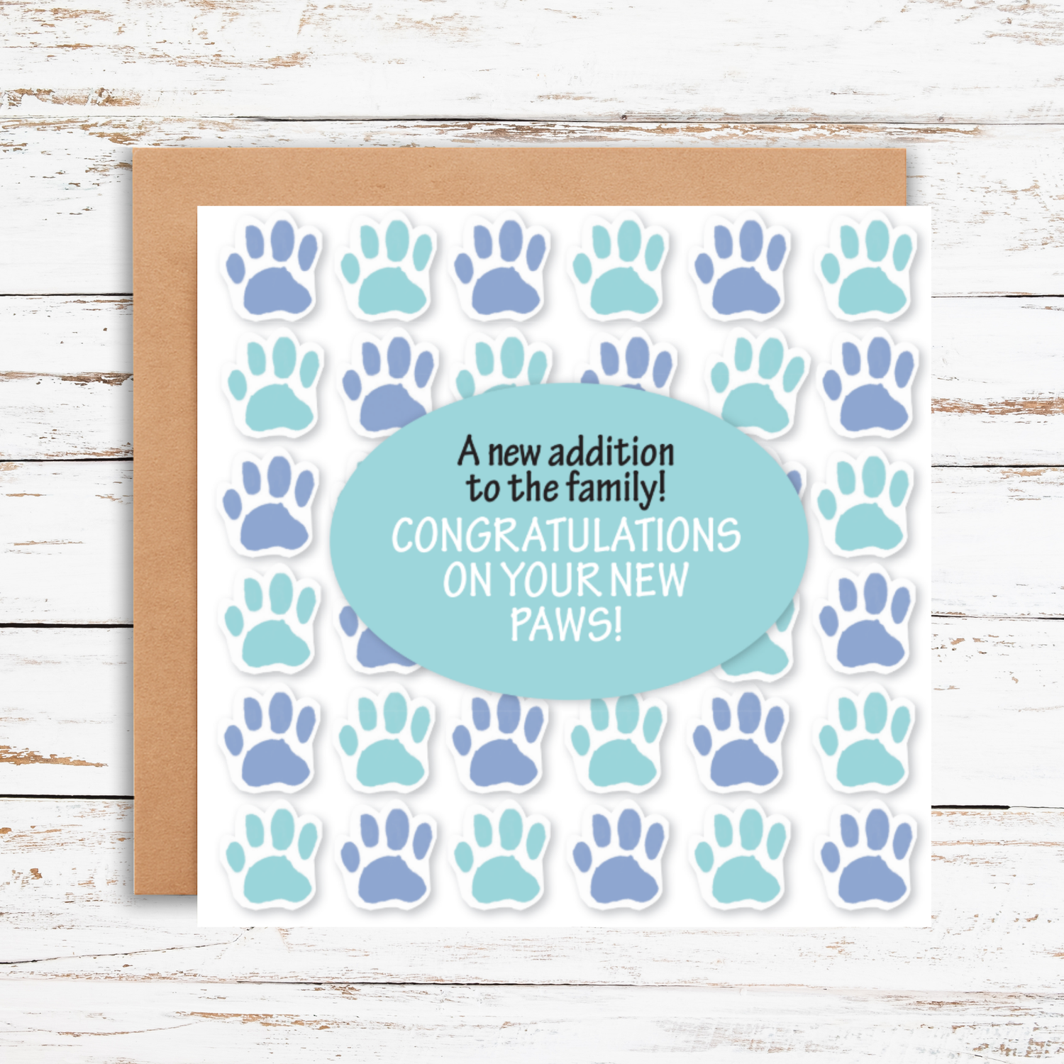 Greeting card with paw prints and text on a wooden surface