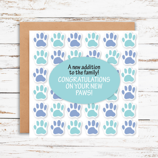 Greeting card with paw prints and text on a wooden surface
