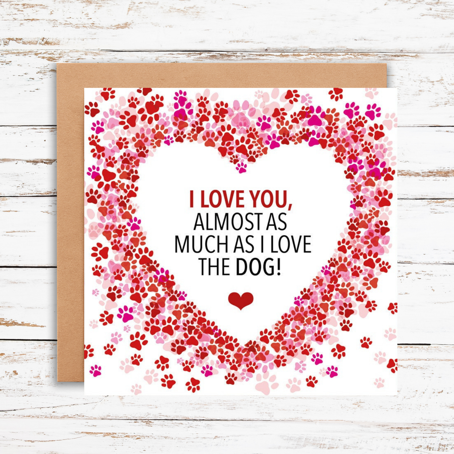 Card with paw print heart design and text on a wooden surface