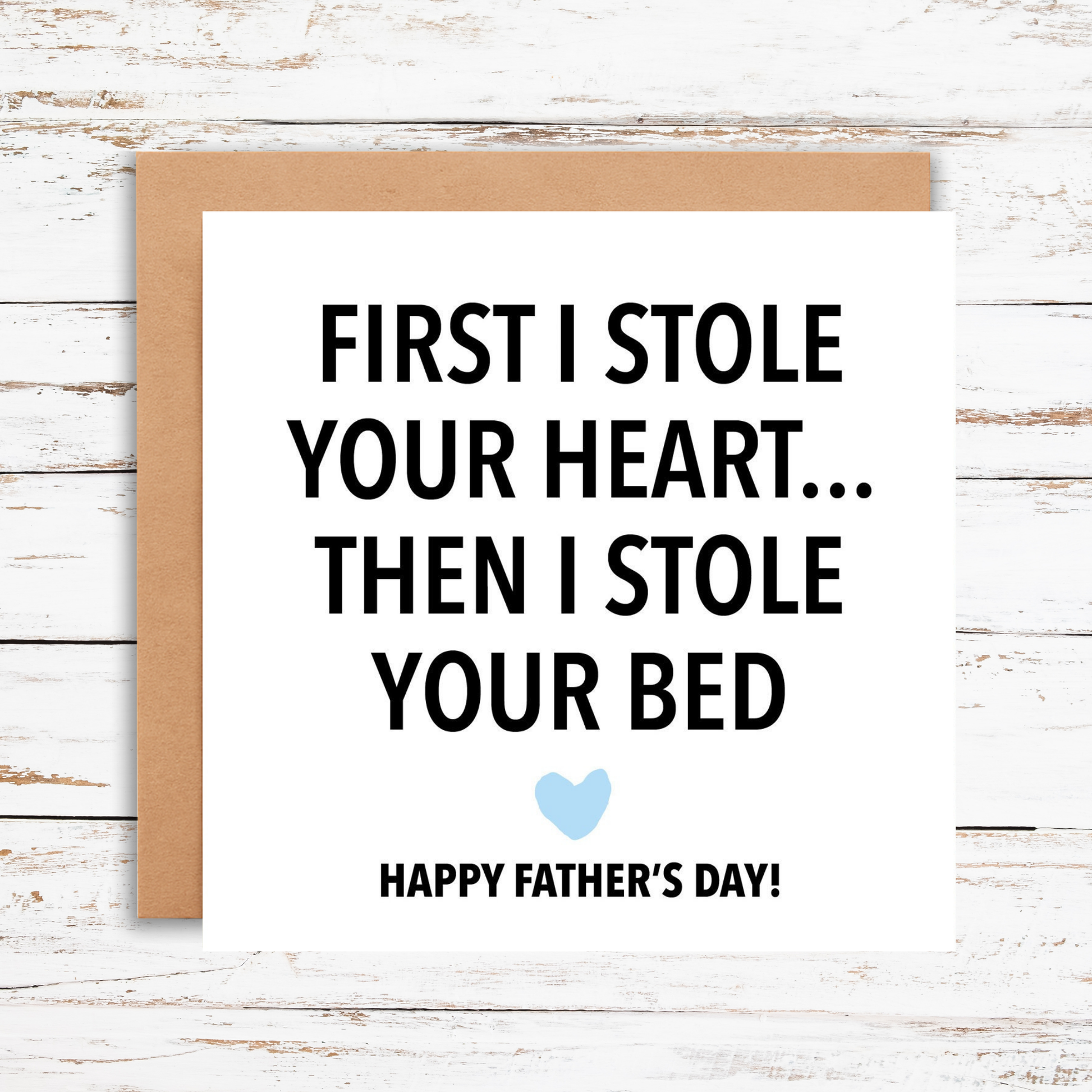 Father's Day card with humorous message on a wooden surface