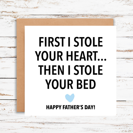 Father's Day card with humorous message on a wooden surface