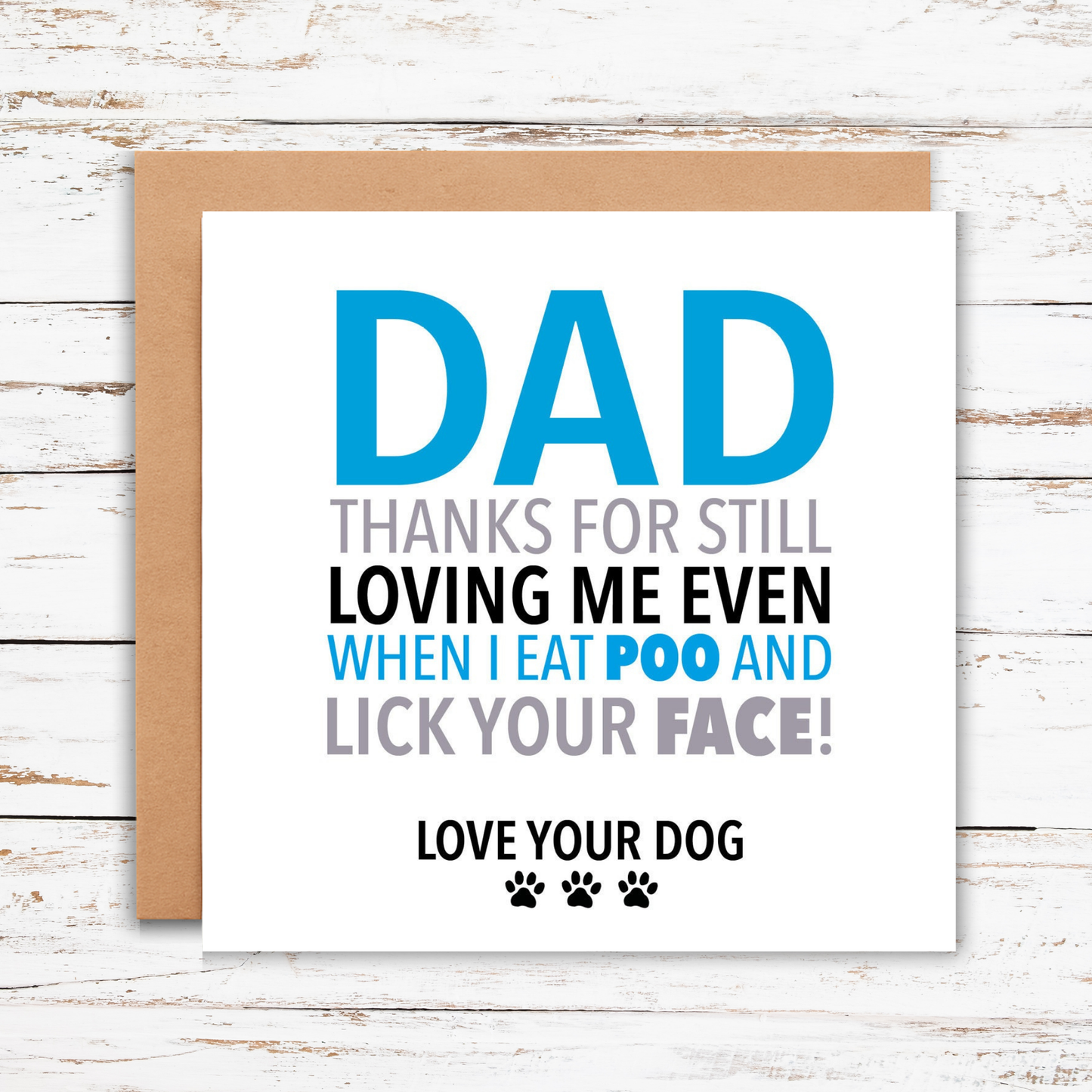 Card with humorous message to a dad from his dog on a wooden surface