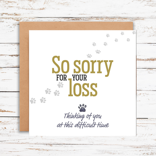 Card with 'So sorry for your loss' text on a wooden surface