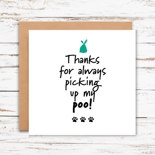Card with text 'Thanks for always picking up my poo!' on a wooden surface