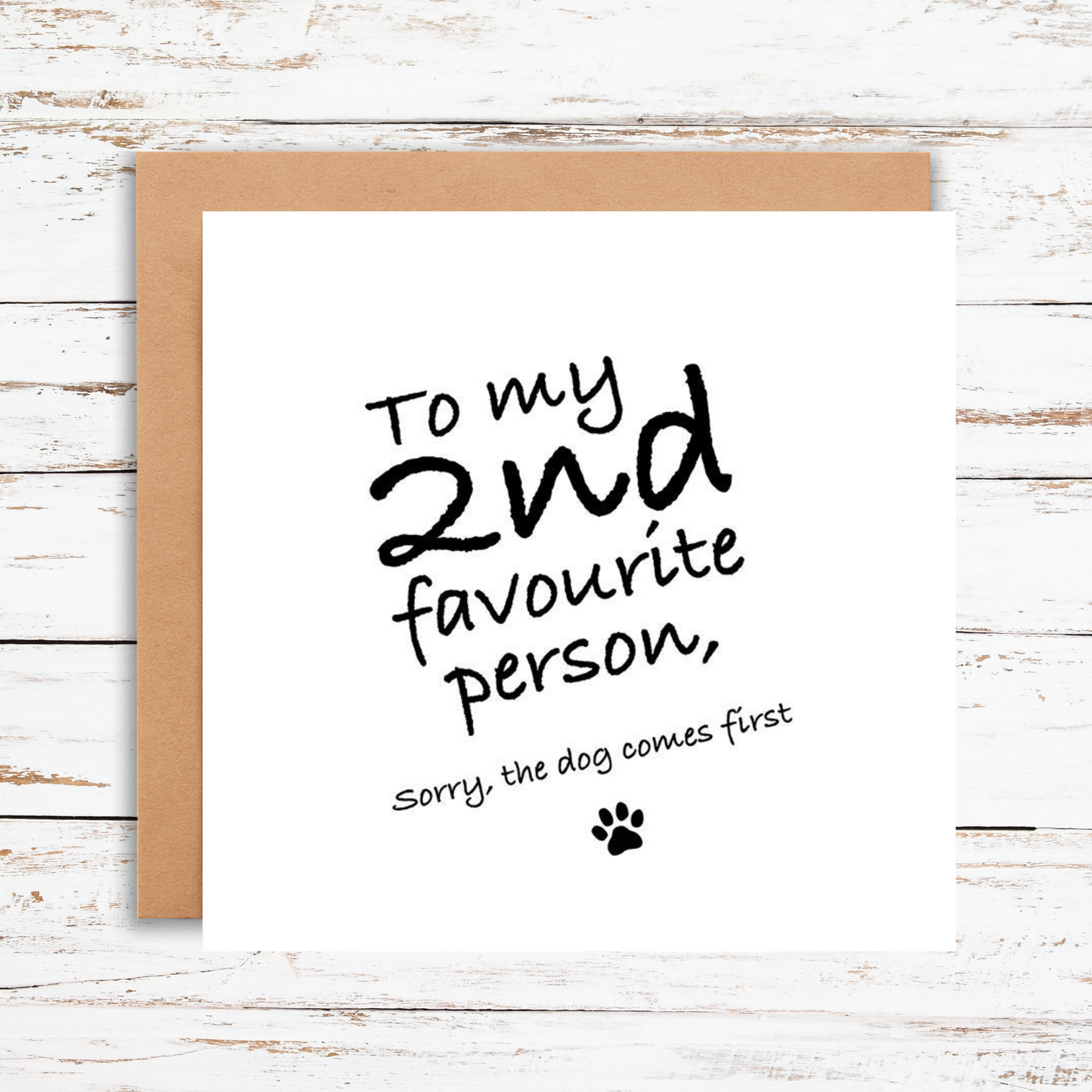 Card with text 'To my 2nd favourite person, sorry the dog comes first' on a wooden surface