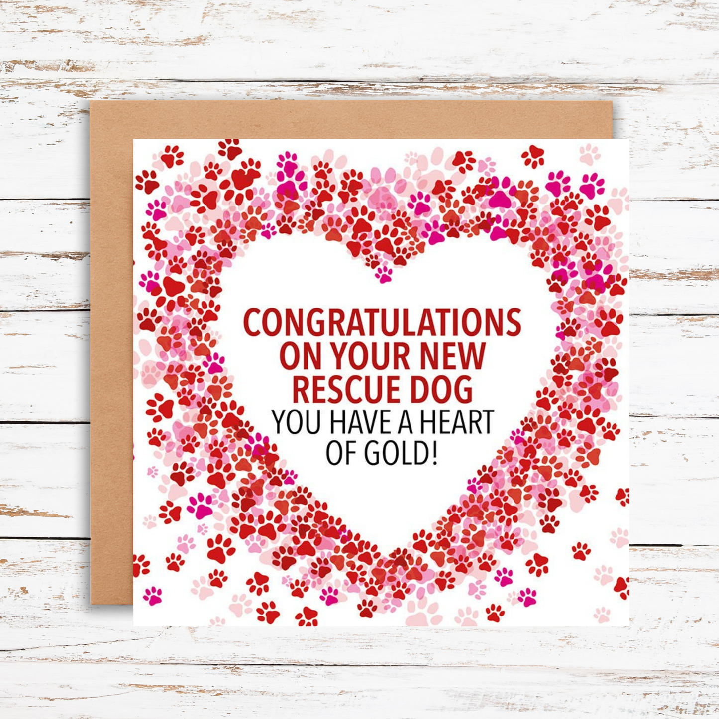 Greeting card with paw print heart design and text on a wooden surface