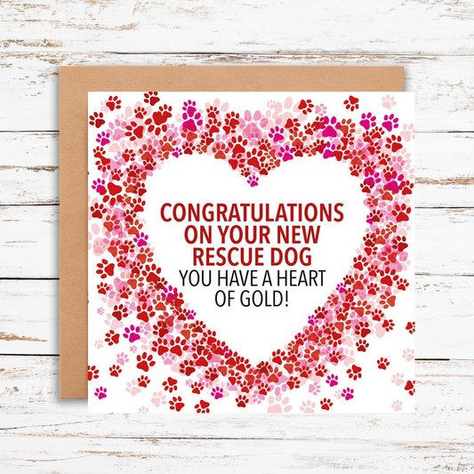 Greeting card with paw print heart design and text on a wooden surface