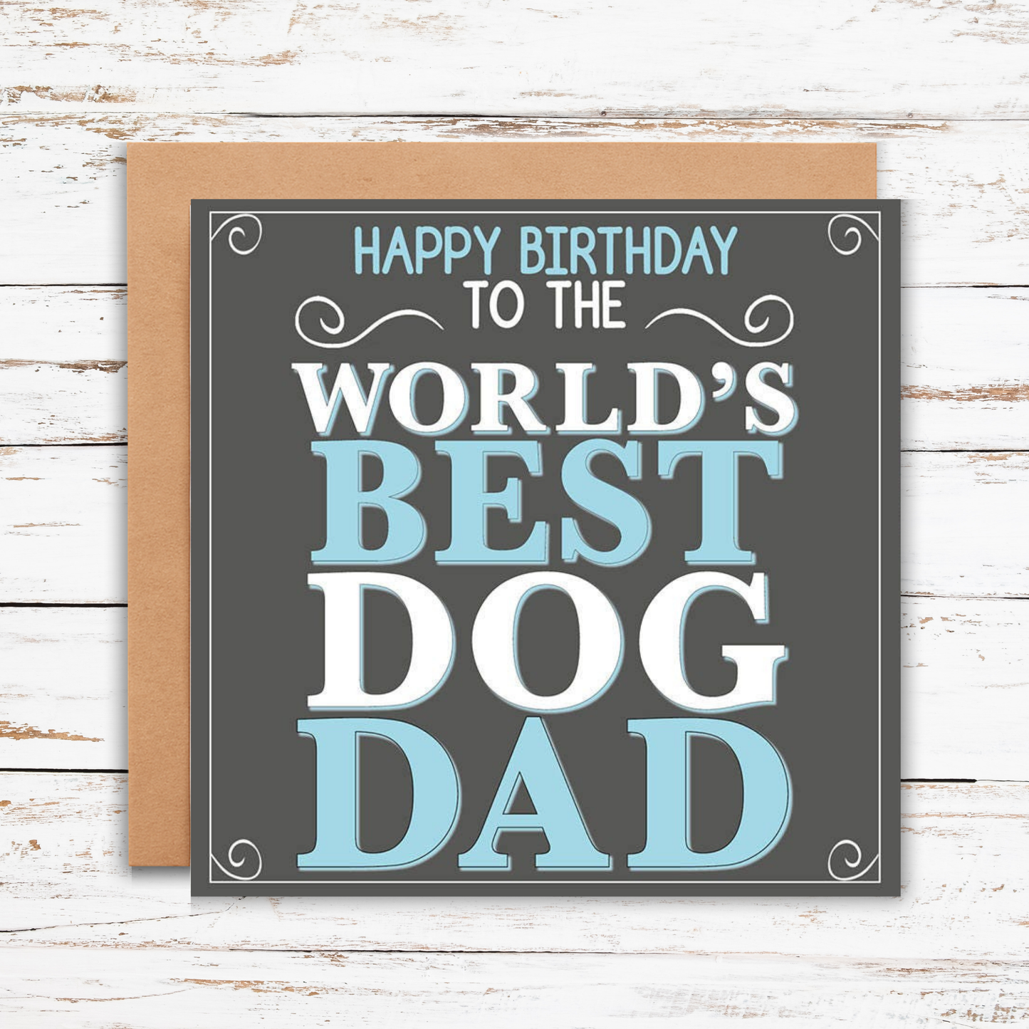 Greeting card with 'Happy Birthday to the World's Best Dog Dad' text on a wooden surface