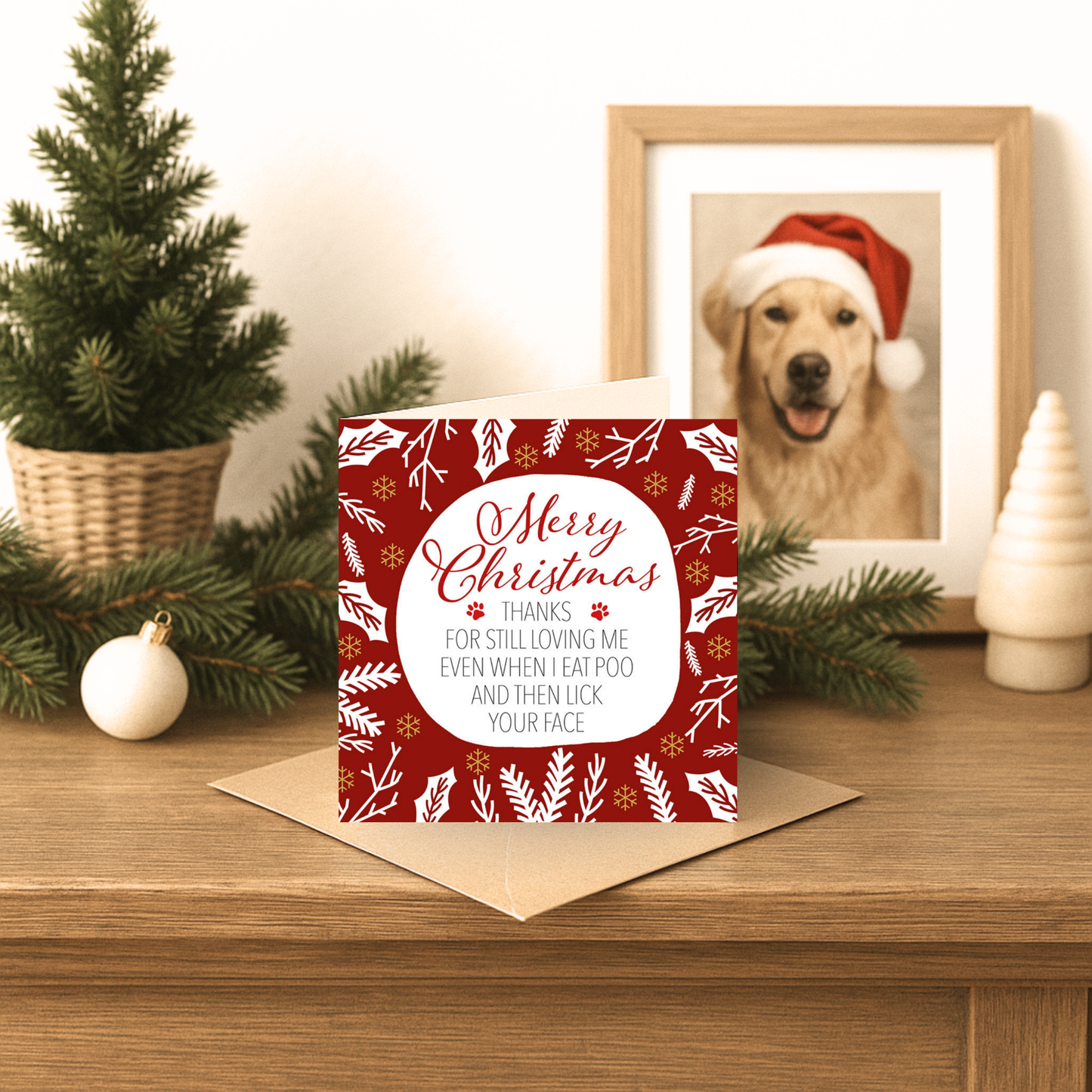 Christmas card with decorative design on a wooden surface with festive decorations.