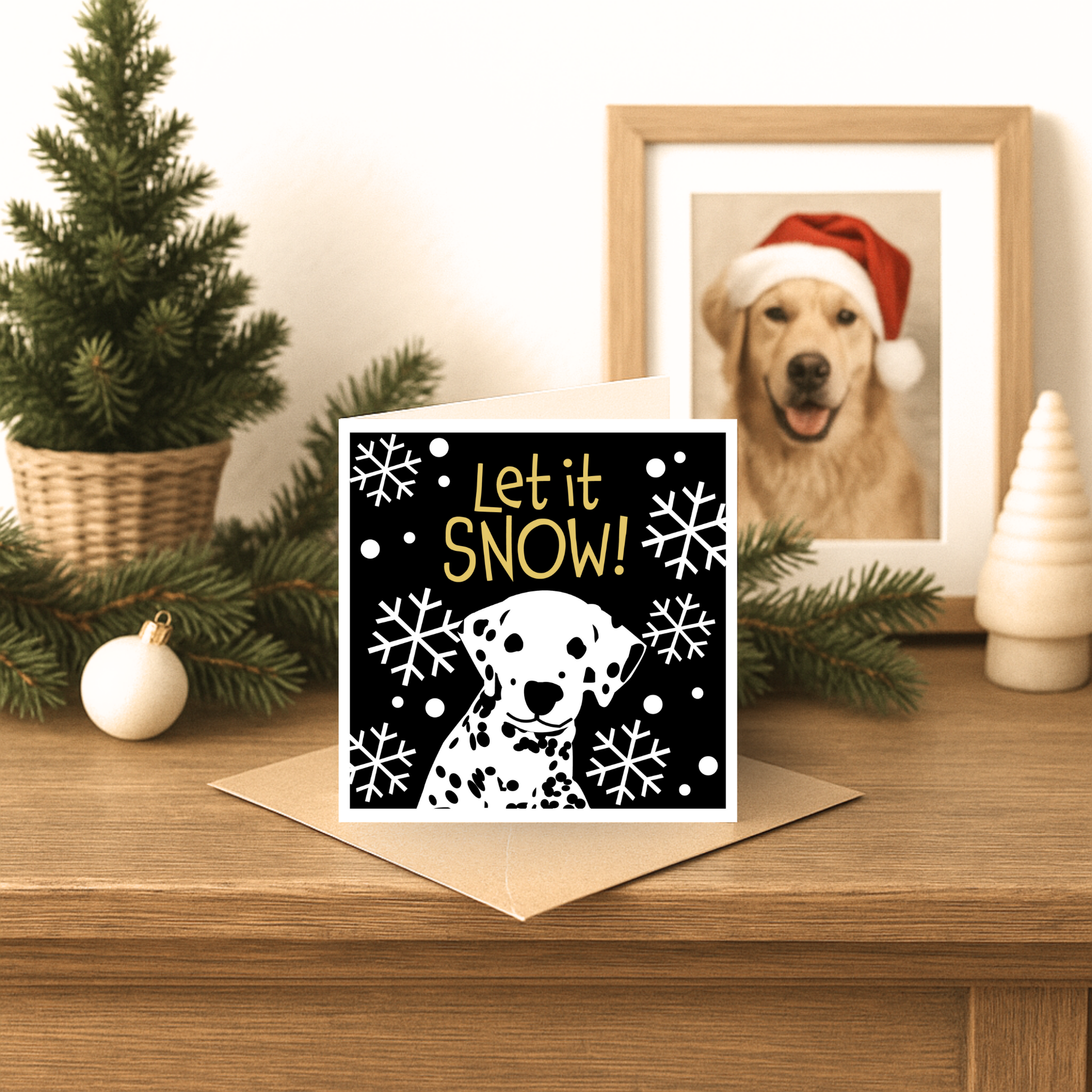 Christmas card with 'Let it Snow!' text and a dog illustration on a wooden surface with festive decorations.