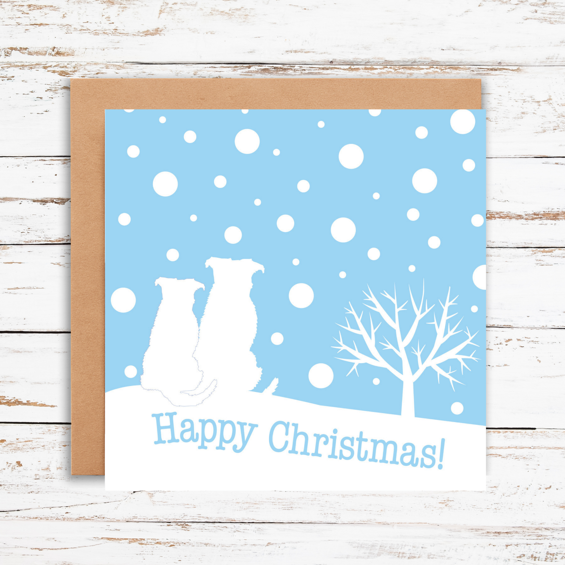 Christmas card with two dogs and a tree on a blue snowy background