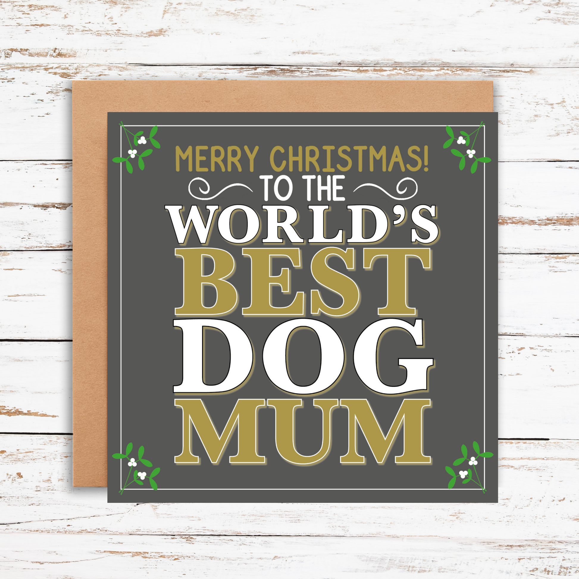 Greeting card with 'Merry Christmas! To the World's Best Dog Mum' text on a wooden surface