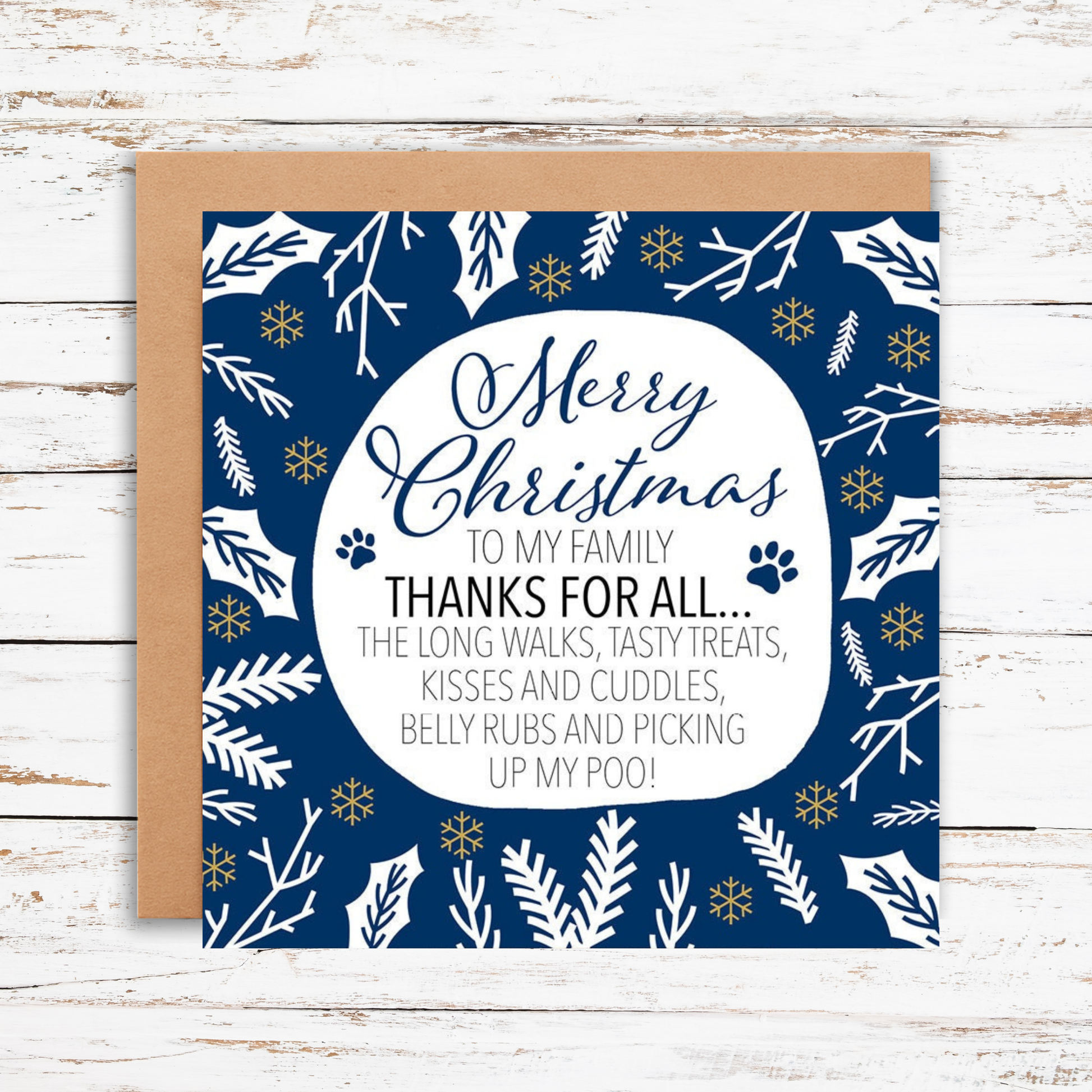 Christmas card with blue and white design and text on a wooden surface