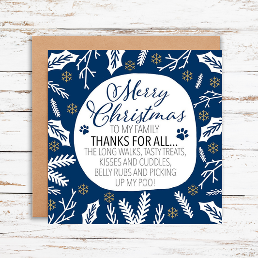 Christmas card with blue and white design and text on a wooden surface