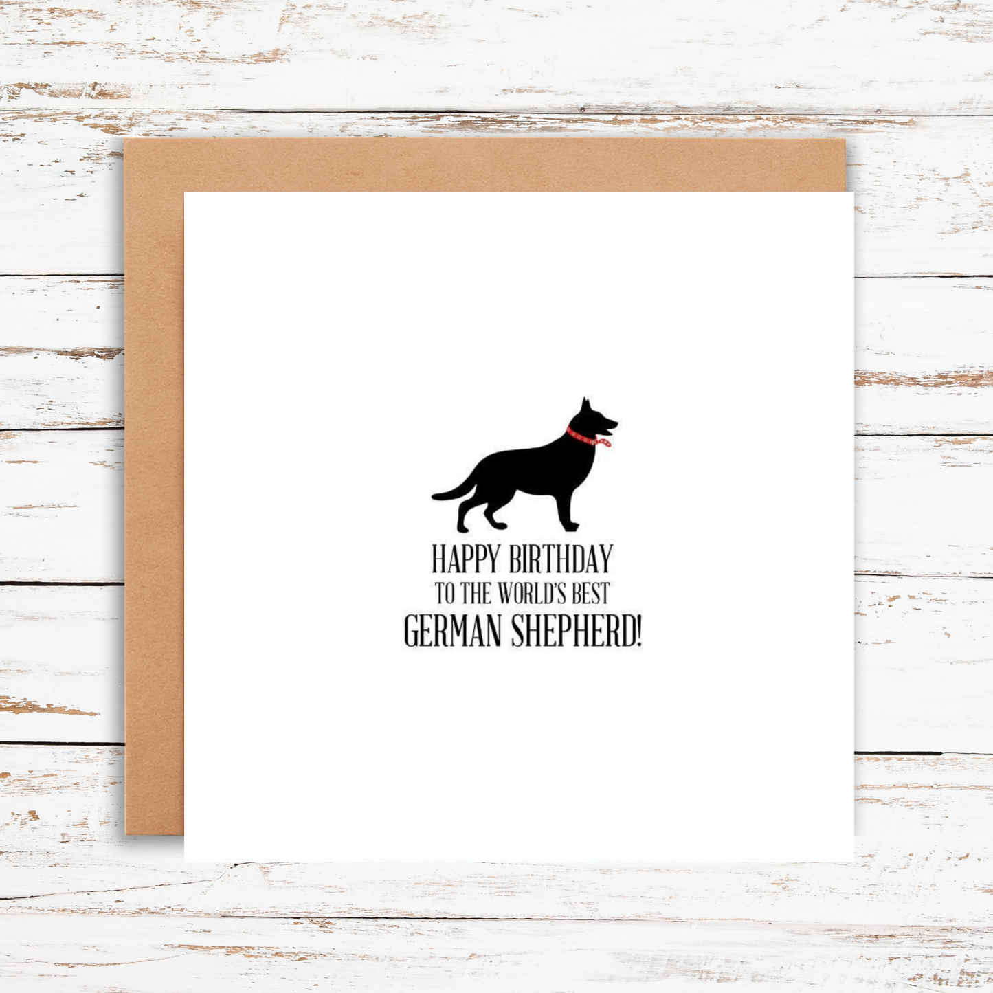 Birthday card with a German Shepherd silhouette and text on a wooden surface