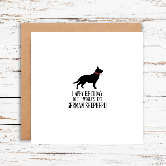 Birthday card with a German Shepherd silhouette and text on a wooden surface