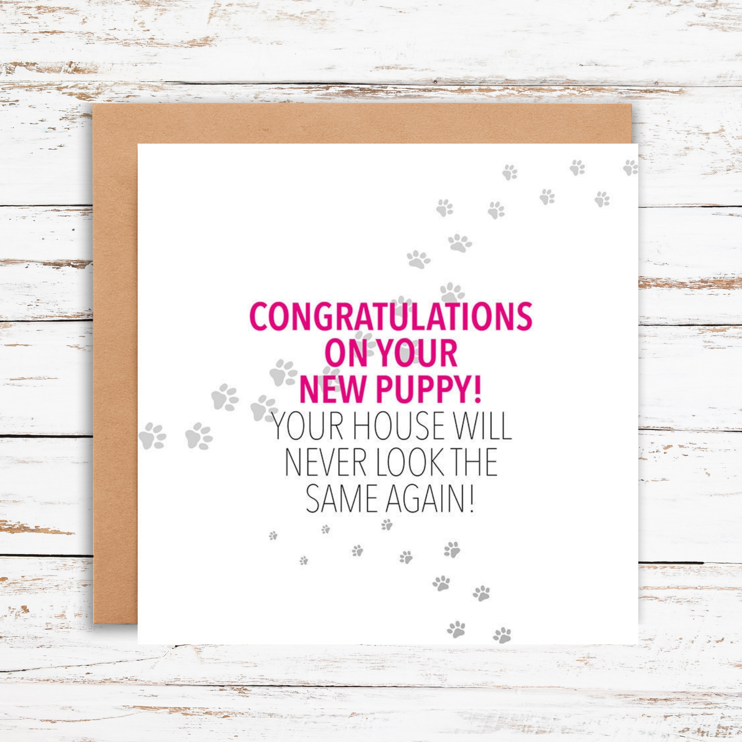 Greeting card with 'Congratulations on your new puppy!' text on a wooden surface