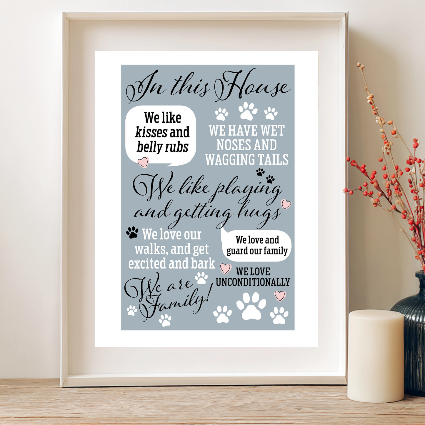 Framed print with text about love for pets on a table with decorative elements.