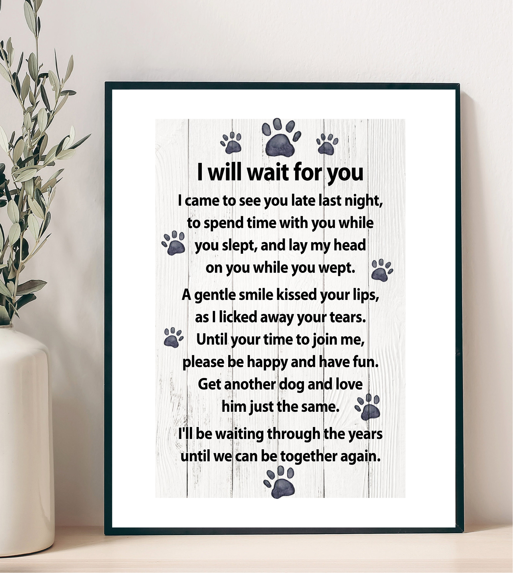 Framed poem with paw prints on a white background, displayed on a shelf.