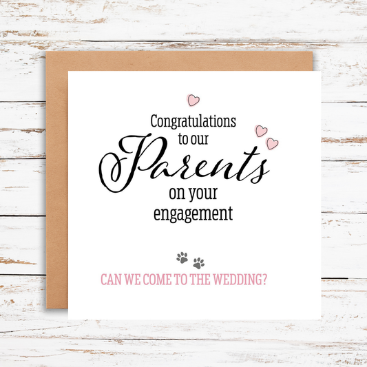Greeting card with congratulations on engagement text and question about wedding invitation on a wooden surface.