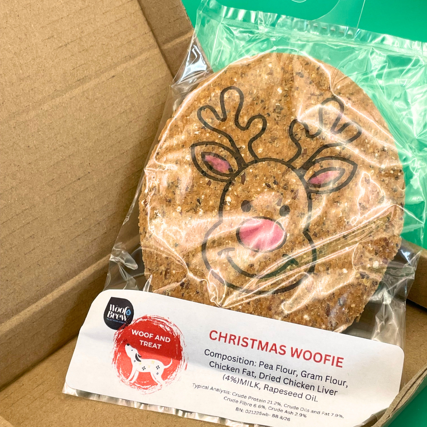 Wrapped ChristmasWoofie treat with reindeer design on a cardboard box