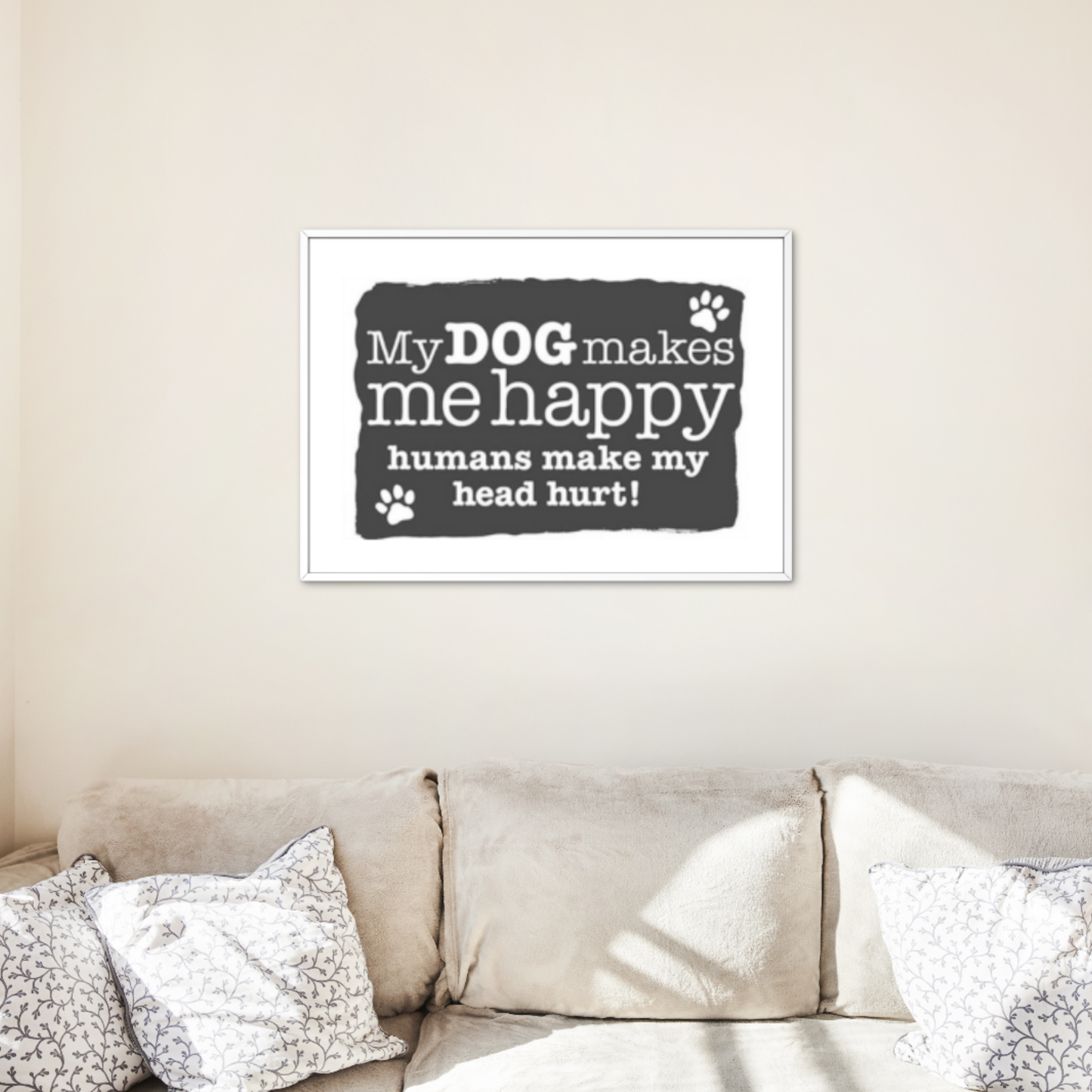Wall art with humorous quote about dogs and humans in a living room setting.