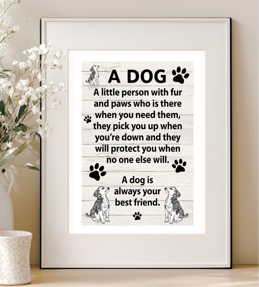 Framed print with a dog-themed quote on a wooden surface with decorative elements.