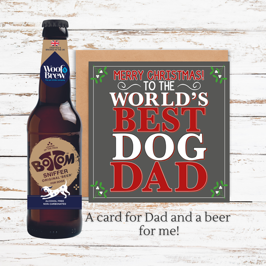Beer bottle and Christmas card for 'World's Best Dog Dad' on a wooden surface