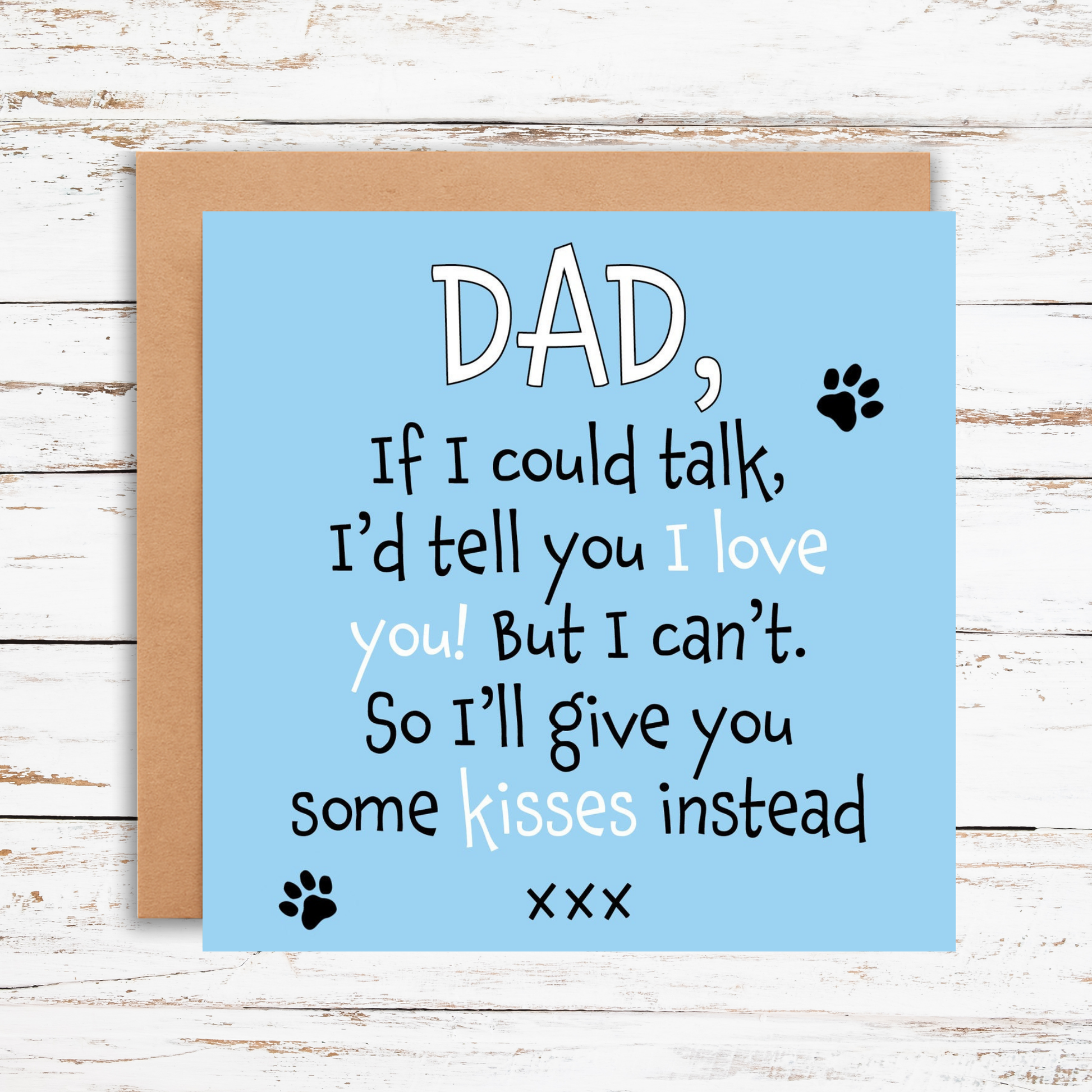 Card with a humorous message for a dad on a wooden surface