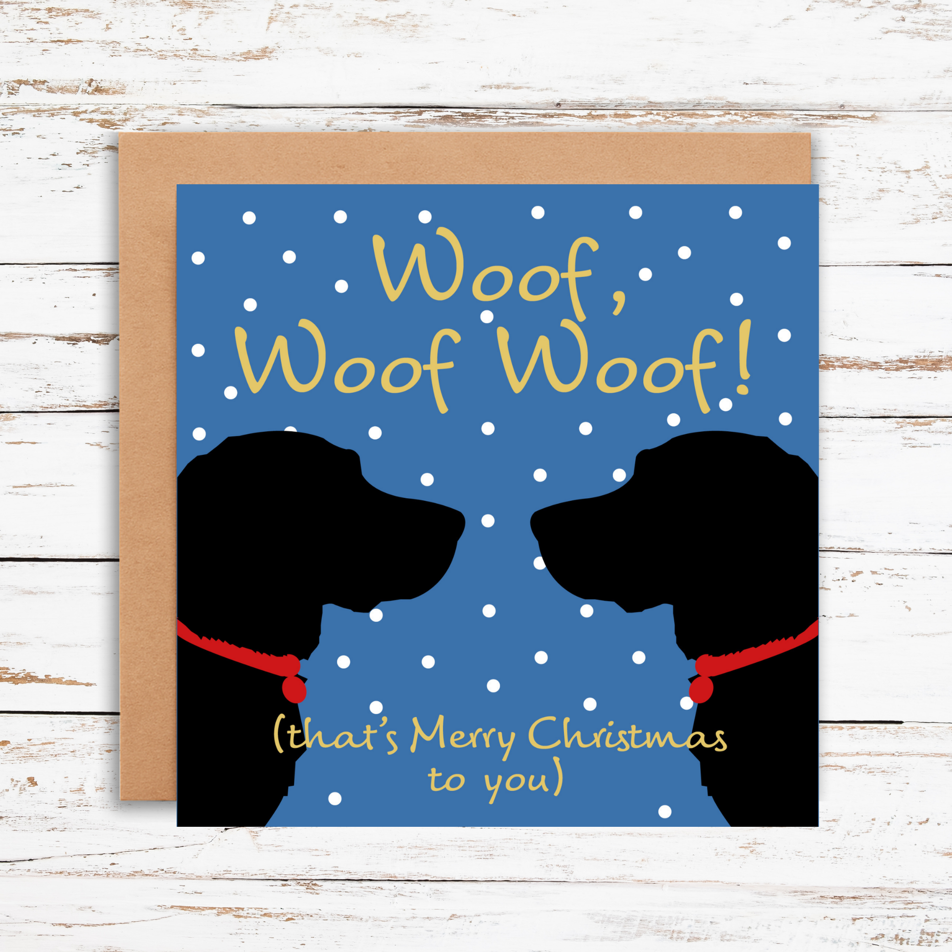 Christmas card with dog silhouettes and 'Woof, Woof Woof! (that's Merry Christmas to you)' text on a blue background.